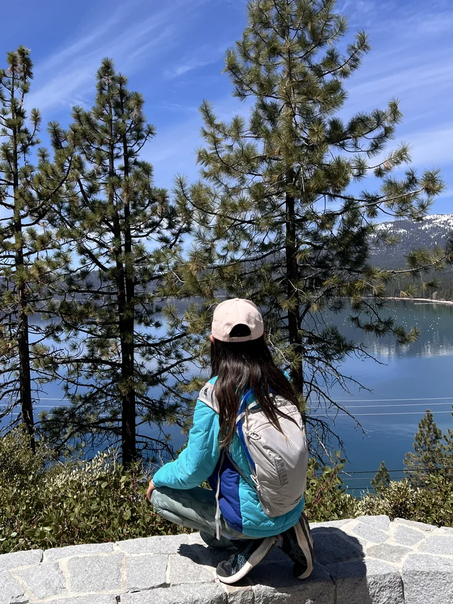 Lauren looking across a mountain lake.